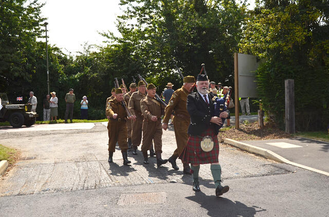 The Oxfordshire Home Guard, led by piper Steve Duffy, marches from the Windmill to Hobart Way