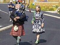 Jo Eames is piped into the commemoration event by piper Steve Duffy, former Scots Guard